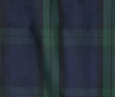 close up fabric detail of green and navy blackwatch plaid