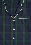 Close up of the collar, chestpocket, and front buttons of a navy blue and green blackwatch plaid pajama top with white buttons and white piping. 