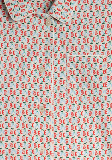 image of the placket area of a red, blue, and green floral patterned pajama shirt 